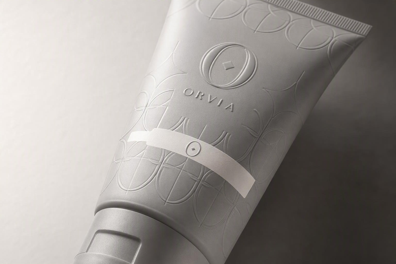 ORVIA skincare tube with tactile raised-UV print